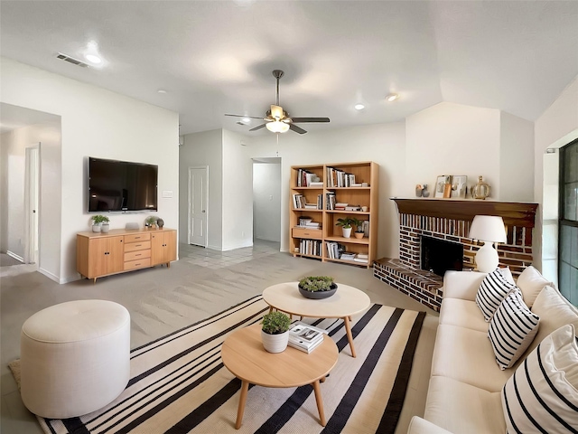 carpeted living room with vaulted ceiling, a brick fireplace, visible vents, and ceiling fan