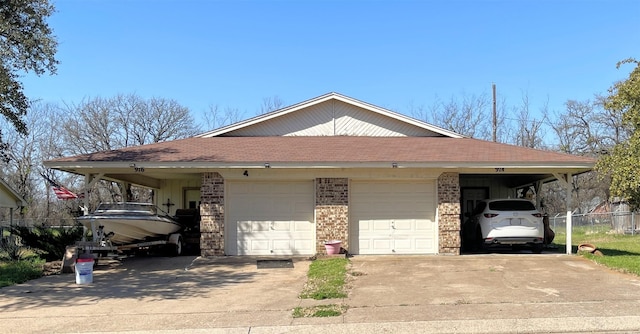 view of front of property featuring concrete driveway, fence, brick siding, and a shingled roof