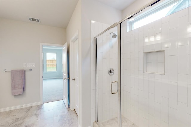 bathroom featuring visible vents, a healthy amount of sunlight, a stall shower, and baseboards