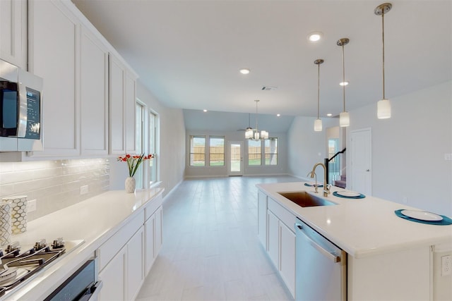 kitchen featuring visible vents, a sink, tasteful backsplash, appliances with stainless steel finishes, and white cabinets