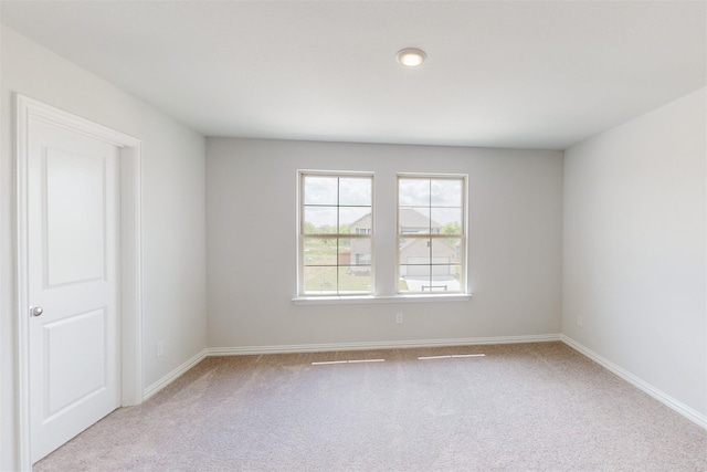 carpeted empty room with baseboards