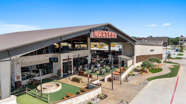 view of building exterior with an outdoor fire pit