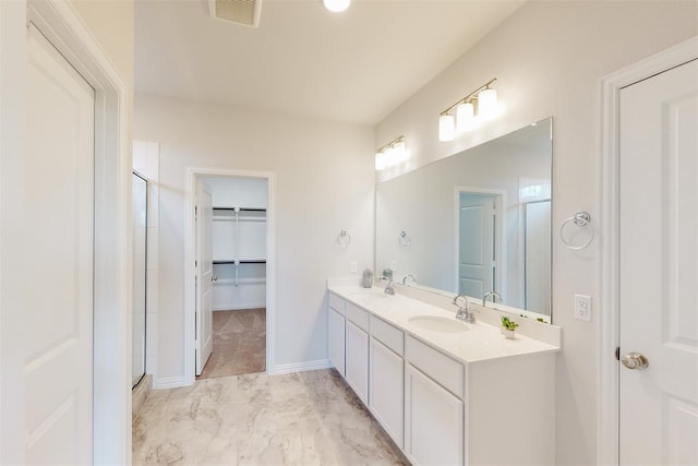 bathroom featuring a stall shower, visible vents, and a sink