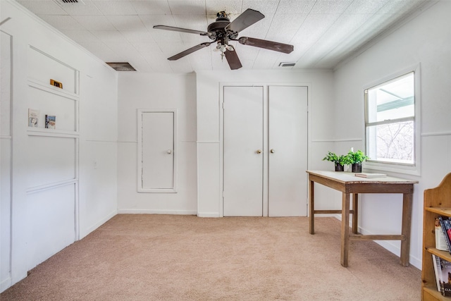 interior space featuring light carpet, visible vents, a ceiling fan, and a closet