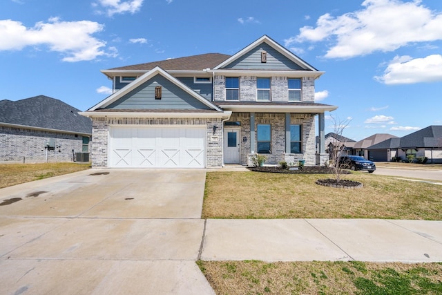 view of front facade with brick siding, a front lawn, concrete driveway, and a garage