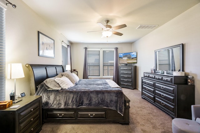 carpeted bedroom with visible vents and ceiling fan