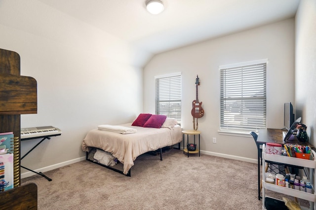 carpeted bedroom with baseboards and vaulted ceiling