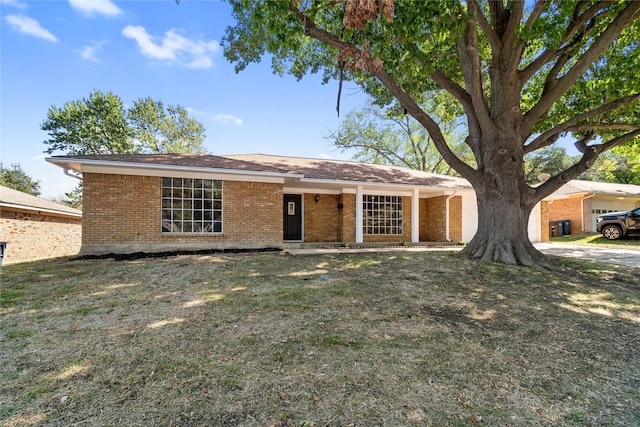 single story home with a front yard and brick siding