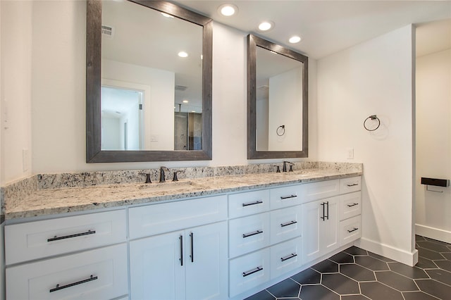 full bathroom with a sink, recessed lighting, double vanity, and tile patterned flooring