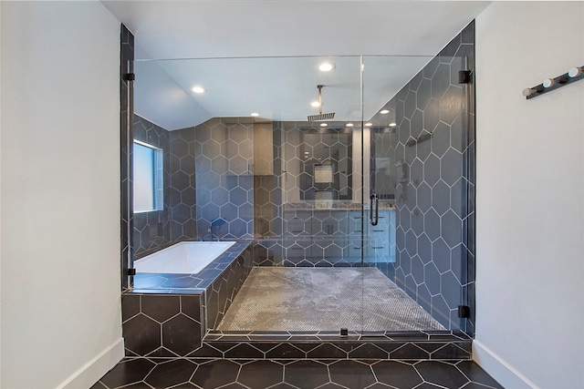 bathroom featuring tile patterned flooring, visible vents, a shower stall, baseboards, and a garden tub