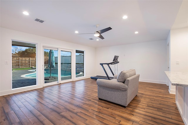 sitting room featuring a ceiling fan, visible vents, baseboards, recessed lighting, and dark wood-style flooring