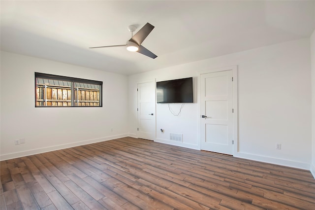 unfurnished living room featuring visible vents, baseboards, a ceiling fan, and wood finished floors