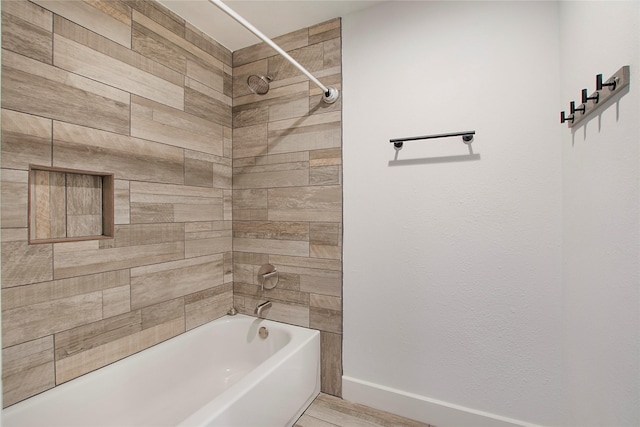 bathroom featuring baseboards and shower / washtub combination