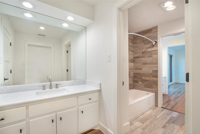 full bathroom with baseboards, recessed lighting, shower / bathtub combination, wood finished floors, and vanity