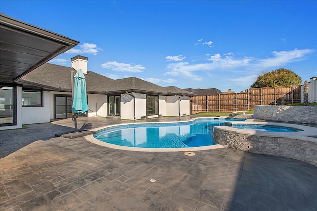 view of pool with a fenced in pool, an in ground hot tub, fence private yard, and a patio