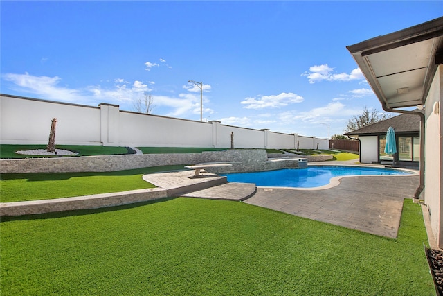 view of swimming pool featuring a lawn, a patio, a fenced backyard, and a fenced in pool