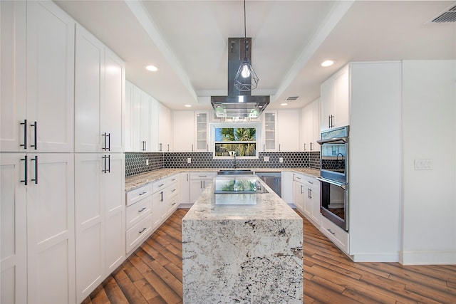 kitchen featuring dark wood finished floors, decorative backsplash, and a sink