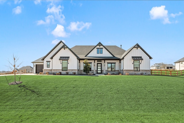 modern farmhouse featuring board and batten siding, a front lawn, fence, an attached garage, and a standing seam roof