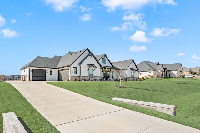 modern farmhouse style home featuring a front yard, an attached garage, a residential view, concrete driveway, and board and batten siding