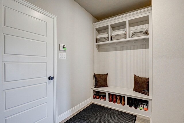 mudroom with baseboards and wood finished floors