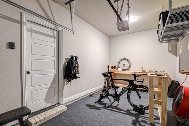 garage with baseboards, a heating unit, and a garage door opener