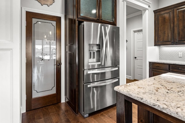 kitchen featuring dark brown cabinetry, decorative backsplash, dark wood finished floors, and stainless steel fridge with ice dispenser