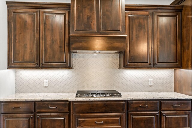 kitchen with dark brown cabinetry and stainless steel gas stovetop