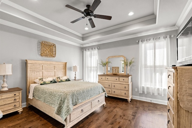 bedroom featuring a tray ceiling, dark wood finished floors, and ornamental molding