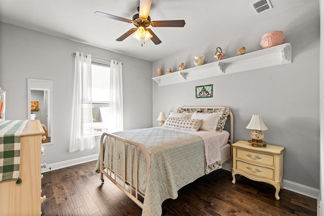 bedroom featuring ceiling fan, wood finished floors, visible vents, and baseboards