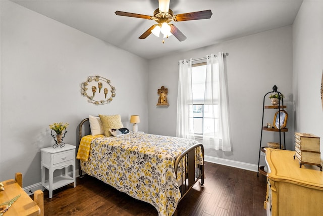 bedroom with baseboards, a ceiling fan, and dark wood-style flooring