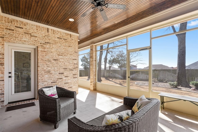 sunroom featuring wood ceiling and a ceiling fan