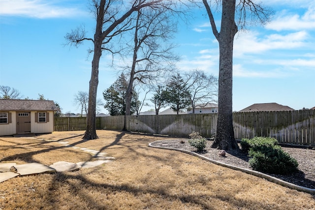 view of yard with an outbuilding and a fenced backyard