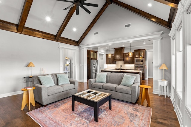 living area featuring visible vents, high vaulted ceiling, decorative columns, ceiling fan, and dark wood-style flooring