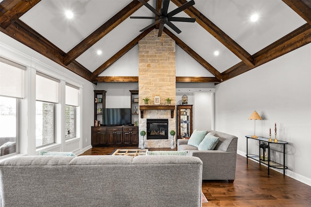 living area featuring dark wood-type flooring, baseboards, beamed ceiling, a fireplace, and high vaulted ceiling