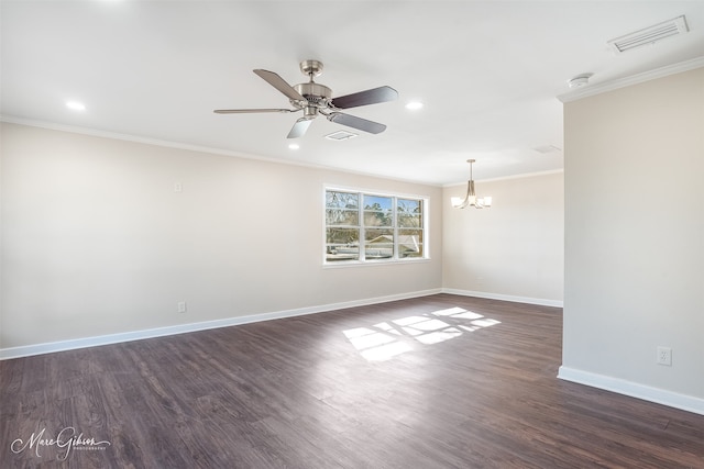 empty room with dark wood finished floors, visible vents, baseboards, and ornamental molding