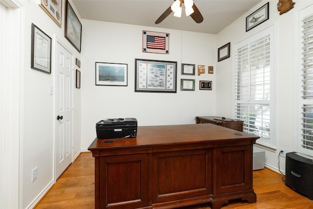 home office with ceiling fan and light wood-style flooring