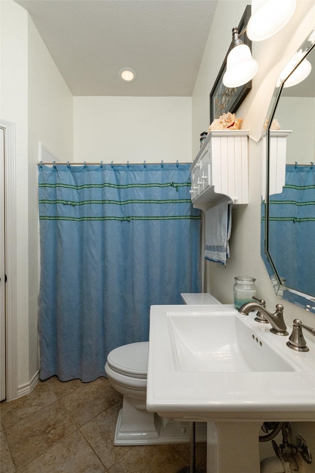 full bathroom with tile patterned flooring and toilet