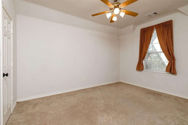 unfurnished room featuring visible vents, light colored carpet, baseboards, and ceiling fan