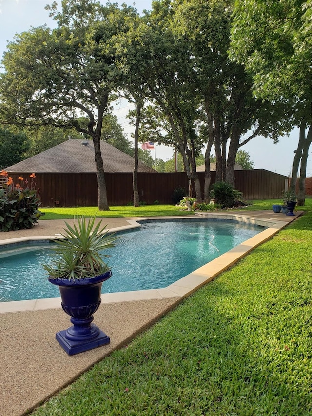 view of pool with a yard, a fenced in pool, and a fenced backyard