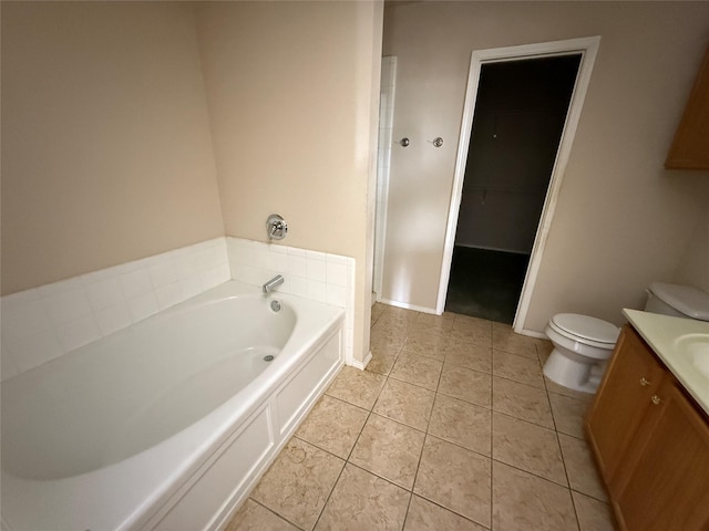 bathroom with a spacious closet, tile patterned floors, toilet, a bath, and vanity