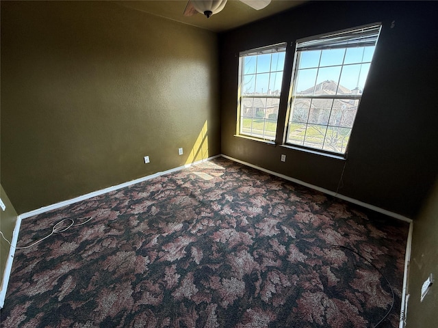 unfurnished room with baseboards and carpet floors