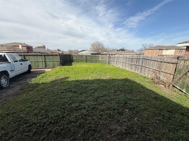 view of yard with a fenced backyard