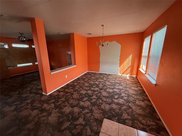 spare room with visible vents, baseboards, a notable chandelier, and carpet flooring