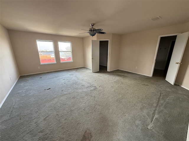 unfurnished bedroom with visible vents, baseboards, ceiling fan, and carpet flooring