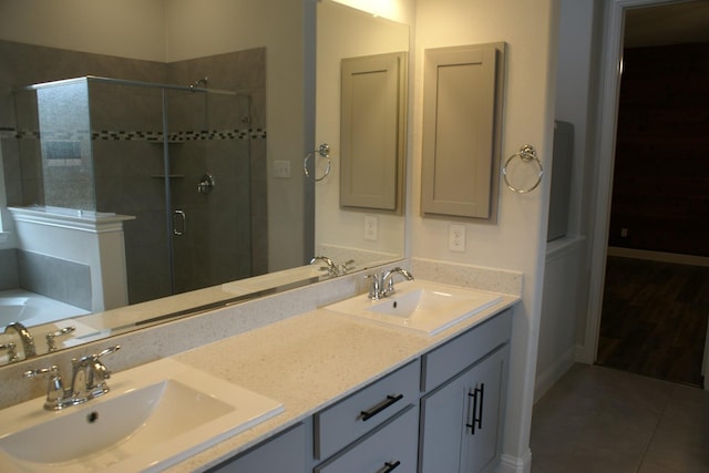 full bathroom featuring a sink, a stall shower, and tile patterned flooring