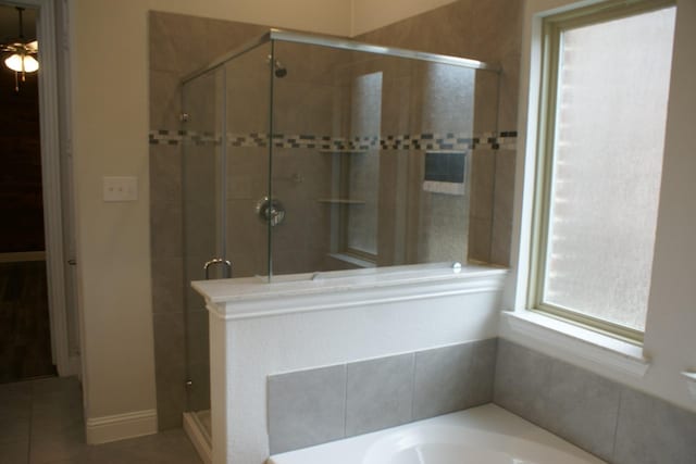 full bath with tile patterned floors, a garden tub, and a stall shower