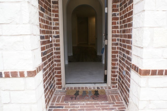 view of exterior entry with brick siding