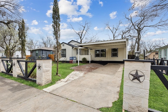 bungalow-style home featuring concrete driveway, a front lawn, and fence