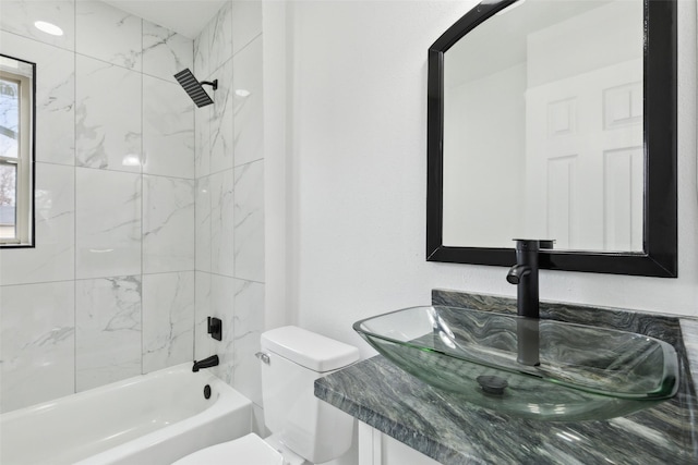 full bathroom featuring tub / shower combination, toilet, and vanity