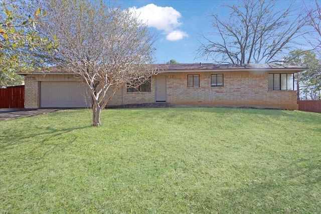 ranch-style home featuring fence, driveway, an attached garage, a front lawn, and brick siding